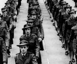 Photograph of servicewomen marching.