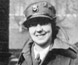 Photograph of a woman wearing a uniform and a hat.