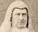 Portrait photograph of Redmond Barry wearing judge's wig and robes.
