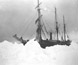 An early Antarctic exploration vessel surrounded by snow.